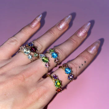 Custom une. Triad Rings on woman's hand with sparkly nails.
